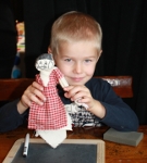 Gustav viser stolt den kludedukke frem, som han selv har lavet i Arbejdermuseets gamle skolestue
