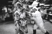 Slaughterman transporting pig carcasses